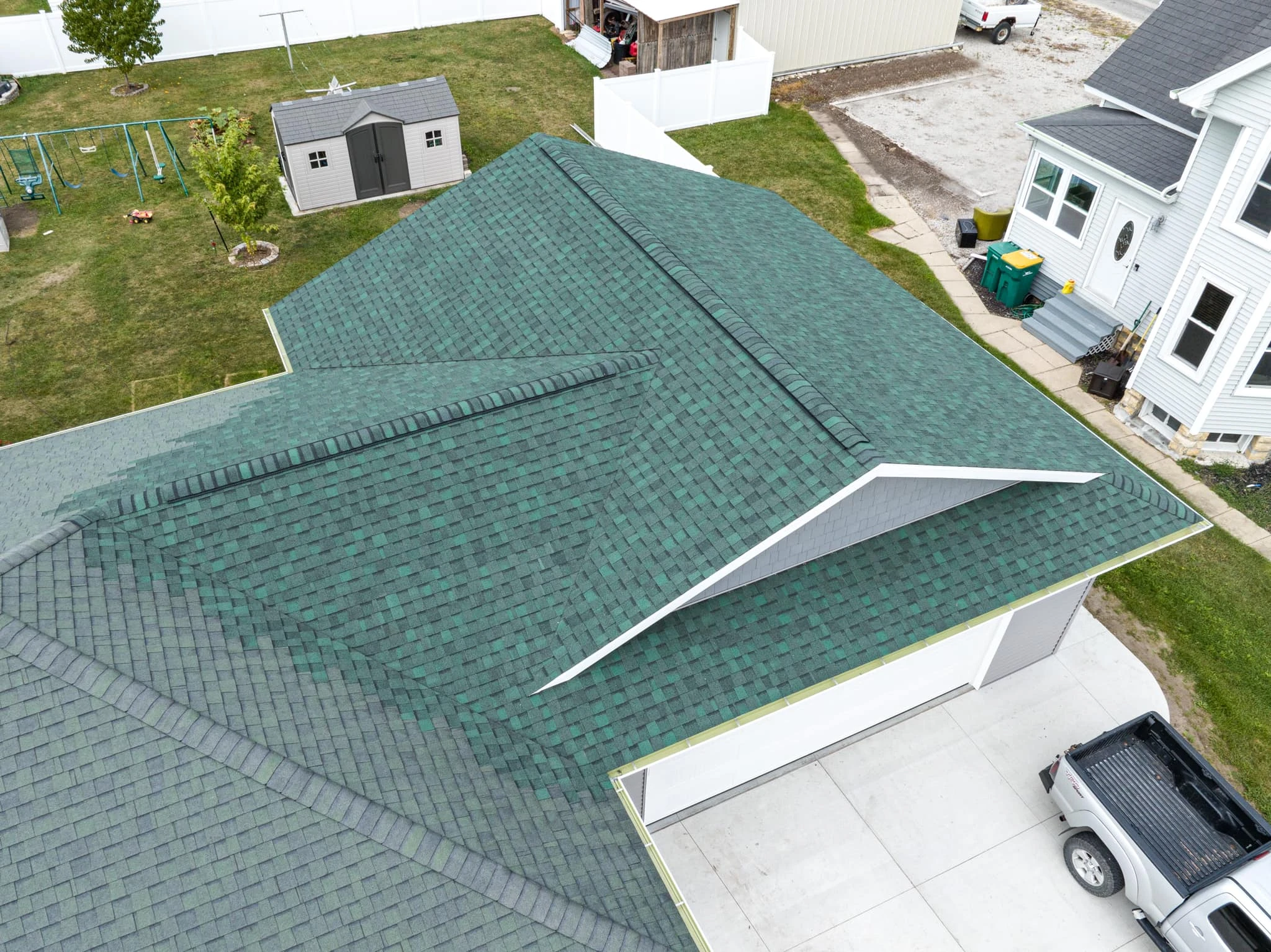 Klawiter Construction crew repairing storm damage on a home's roof and siding