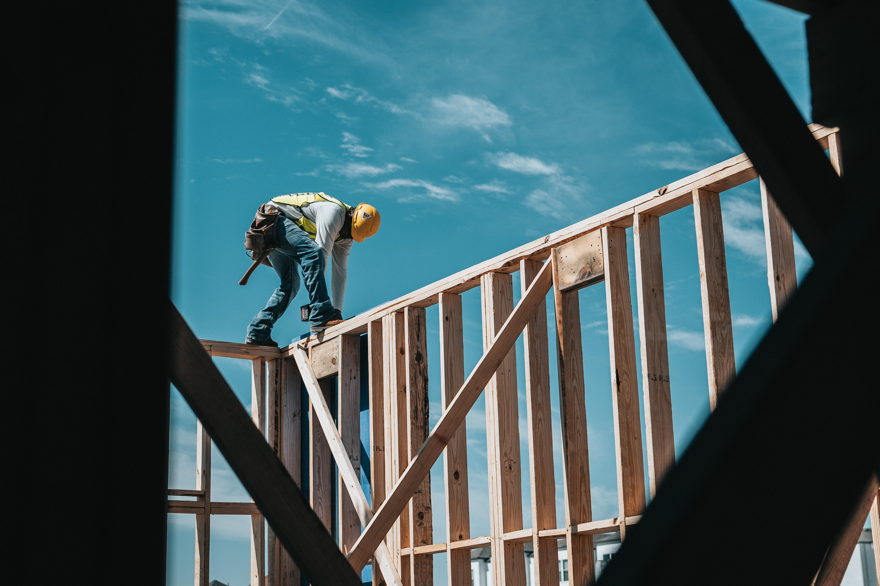 man working on roof frame